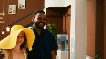 Travellers at reception lobby in hotel, arriving on summer vacation at tropical resort. Guests couple on honeymoon trip talking to front desk staff about leisure activities and check in process. photo