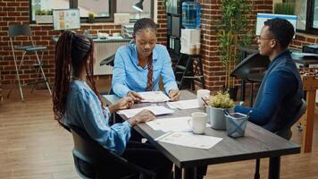 Group of people brainstorming new ideas in business office, finding management solutions for company development. Coworkers checking analytics in briefing meeting, coworking space. photo