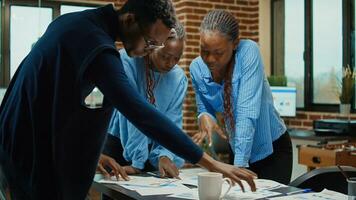 Startup team creating business vision, analyzing statistics on papers and planning company development. Coworkers discussing about startup results to increase profit, meeting in boardroom. photo