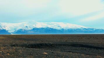 Snowy mountains and icelandic fields in scandinavian landscapes, beautiful countryside scenery with frozen hills. Fantastic outdoor iceland nature with cold weather. Handheld shot. photo