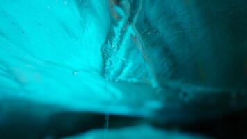 Vatnajokull blue ice rock inside glacier crevasse in icelandic scenery, arctic landscape with icy cracked rocks. Transparent structure in ice cave, frosty polar destination. Handheld shot. photo