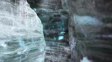 Inside crevasse in vatnajokull polar cap with cracked ice blocks structure, covered frost landscape. Massive transparent glacier in wintry icelandic scenery, icy frosty rocks. Handheld shot. photo