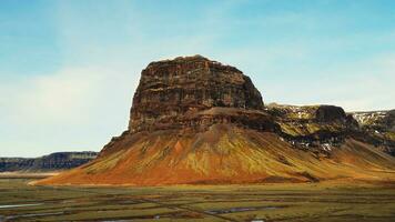 Aerial view of fantastic mountain top in iceland, massive mountain chain with frosty hills near snowy countryside fields. Spectacular icelandic landscape with polar nature and lands. Slow motion. photo