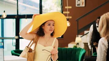 Exotic hotel guest at reception in lobby, waiting to do check in registration procedure with receptionist. Woman on tropical seaside vacation arriving at international summertime resort. photo