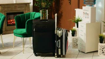 Trolley bags baggage in hotel reception and lounge area, clients luggage and modern decorations at resort front desk. Luxurious furniture at hotel reception entrance, registration. photo