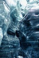 Inside crevasse in vatnajokull ice mass with cracked icy blocks transparent structure, covered frost scenery. Massive arctic icebergs forming glacier cap in wintry icelandic landscape. photo