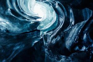 Huge rocks of ice inside vatnajokull glacier crevasse in icelandic landscapes, majestic transparent frozen icy blocks. Ice caves with frosty textured stones covered in frost, glacier hiking. photo