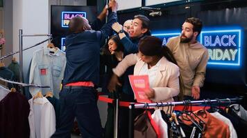 Black friday clients tired of waiting, angry obsessed shoppers eager to start shopping. Customers arguing with security employee, demanding to open store during seasonal sales. photo