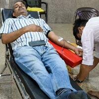 Delhi, India, June 19 2023 - Blood donor at Blood donation camp held at Balaji Temple, Vivek Vihar, Delhi, India, Image for World blood donor day on June 14 every year, Blood Donation Camp at Temple photo