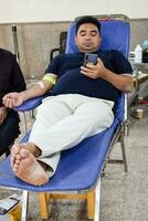 Delhi, India, June 19 2023 - Blood donor at Blood donation camp held at Balaji Temple, Vivek Vihar, Delhi, India, Image for World blood donor day on June 14 every year, Blood Donation Camp at Temple photo