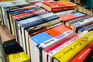 New Delhi, India, August 9 2023 - Variety of Books on shelf inside a book-stall at Delhi International Book Fair, Selection of books on display in Annual Book Fair. photo