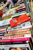 New Delhi, India, August 9 2023 - Variety of Books on shelf inside a book-stall at Delhi International Book Fair, Selection of books on display in Annual Book Fair. photo