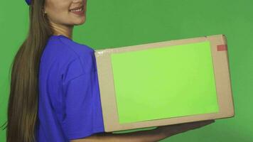 Cropped rearview shot of a smiling delivery woman holding cardboard box video