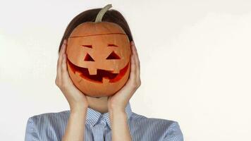 Beautiful woman smiling joyfully holding up Halloween pumpkin video