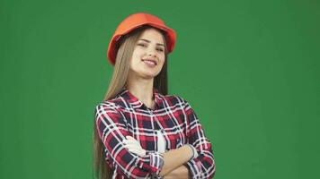 Gorgeous female construction worker in a hardhat smiling to the camera confidently video