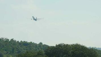 Long shot of a jet plane with an unrecognizable livery gaining altitude after takeoff video