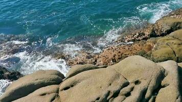Surfer waves turquoise blue water rocks cliffs boulders Puerto Escondido. video