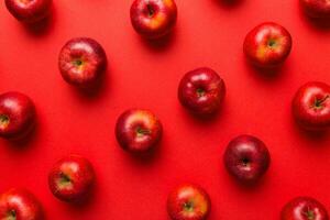 Many red apples on colored background, top view. Autumn pattern with fresh apple above view photo