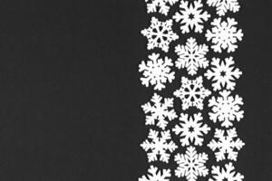 Top view of white snowflakes on colorful background. Winter weather concept with copy space. Merry Christmas concept photo