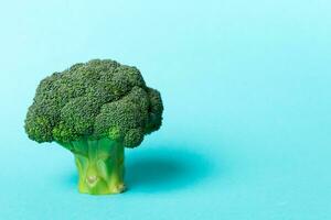 Top view fresh green broccoli vegetable on Colored background. Broccoli cabbage head Healthy or vegetarian food concept. Flat lay. Copy space photo