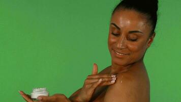 Woman smiling while applying body cream video