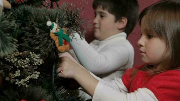 Children decorate the christmas tree video