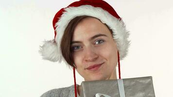 Attractive Christmas woman hiding her face behind a present box video