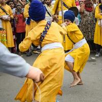 Delhi, India, October 2, 2023 - Sikhs display gatka and martial arts during annual Nagar Kirtan, Traditional, procession on account of birthday of Guru Nanak Dev ji, Nagar Kirtan in East Delhi area photo