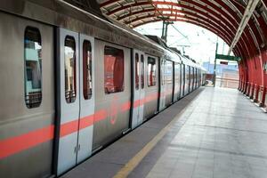 New Delhi India - August 10 2023 - Delhi Metro train arriving at Jhandewalan metro station in New Delhi, India, Asia, Public Metro departing from Jhandewalan station photo