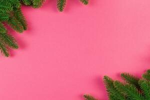 Top view of colorful festive background made of fir tree branch. Christmas holiday concept with copy space photo