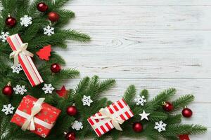 Christmas decorations and fir tree branch and gift boxon dark table. Top view frame with copy space photo