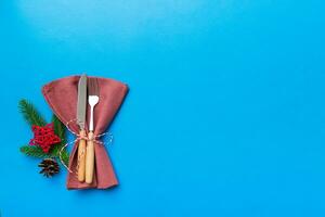 Christmas table place setting with knife, napkin and fork. Holidays new year background with copy space photo