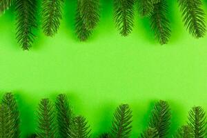 Top view of frame made of fir tree on colorful background with copy space. Merry Christmas concept photo