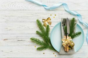 Christmas table place setting with christmas decor and plates, kine, fork and spoon. Christmas holiday background. Top view with copy space photo