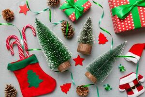 Flat lay composition with christmas trees on color background. Top view with copy space photo