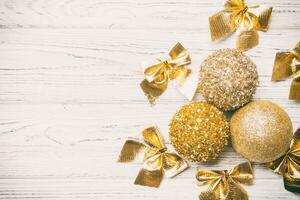 Top view of Christmas balls and creative decorations on wooden background with copy space. New Year concept photo