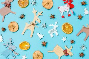 Top view of holiday decorations and toys on blue background. Christmas ornament concept photo