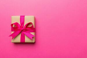 Holiday present box over colored background, top view. Copy space for design photo