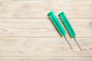 Top view of syringes on wooden background with copy space. Medical equipment for injection concept photo