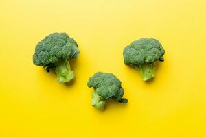 green fresh broccoli background close up on colored table. Vegetables for diet and healthy eating. Organic food photo