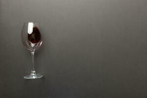 One glasses of red wine at wine tasting. Concept of red wine on colored background. Top view, flat lay design photo