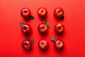 Many red apples on colored background, top view. Autumn pattern with fresh apple above view with copy space for design or text photo