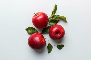 Many red apples on colored background, top view. Autumn pattern with fresh apple above view with copy space for design or text photo