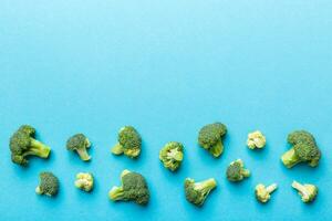 Top view fresh green broccoli vegetable on Colored background. Broccoli cabbage head Healthy or vegetarian food concept. Flat lay. Copy space photo