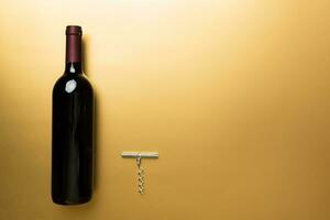 One Bottle of red wine on colored table. Flat lay, top view wth copy space photo