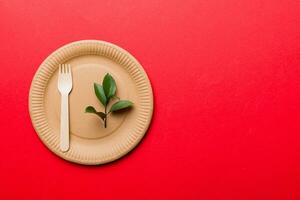 set of empty reusable disposable eco-friendly plates, cups, utensils on light white colored table background. top view. Biodegradable craft dishes. Recycling concept. Close-up photo