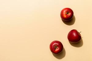 Many red apples on colored background, top view. Autumn pattern with fresh apple above view with copy space for design or text photo