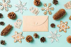 Top view of craft envelope, holiday toys and decorations on blue Christmas background. New Year time concept photo