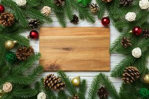 Festive table decoration with New Year branches and dekor an empty plate. Top view with space for text. Christmas time photo