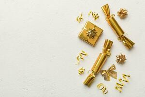 Christmas crackers with shiny confetti on color background, top view, copy space photo